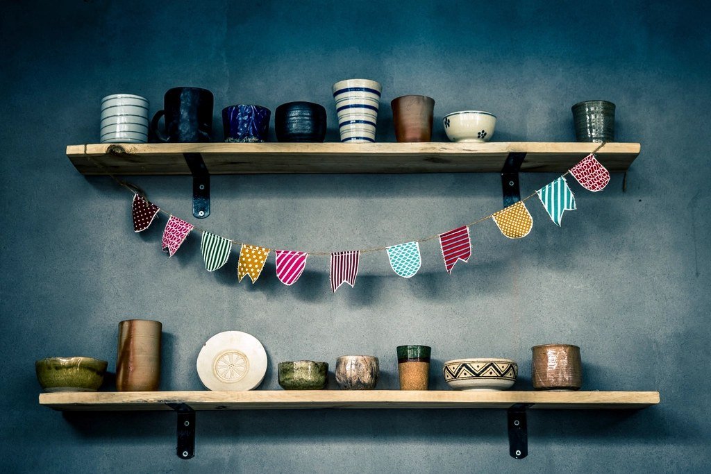 Kitchenware displayed on wall shelves